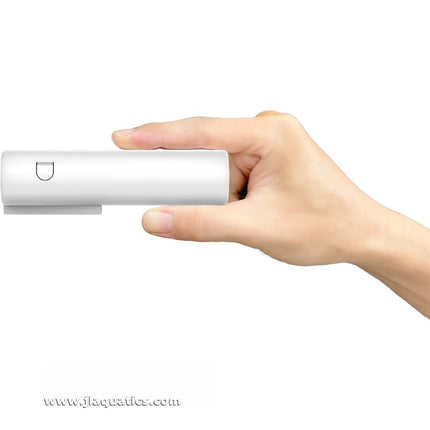 AutoAqua Smart Doser 2 being held showing how thin the unit is compared to other aquairum dosers.